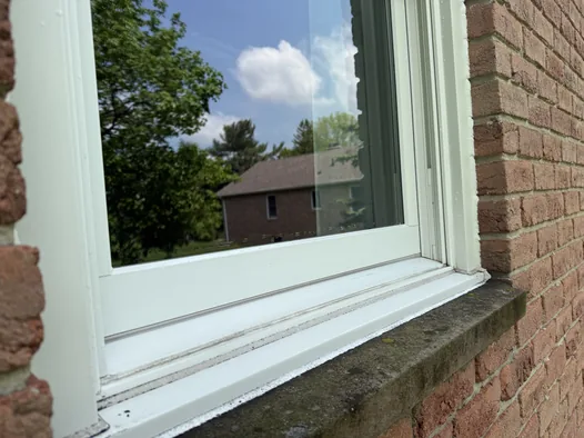 The same Medina window sill and track after cleaning, white and clear